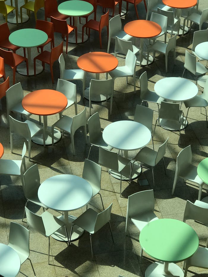 Aerial view of colorful tables and chairs in a modern bistro setting.