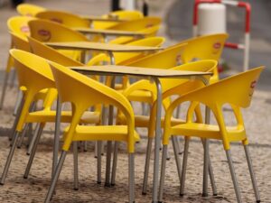 Bright Yellow Plastic Chairs and Tables on the Street