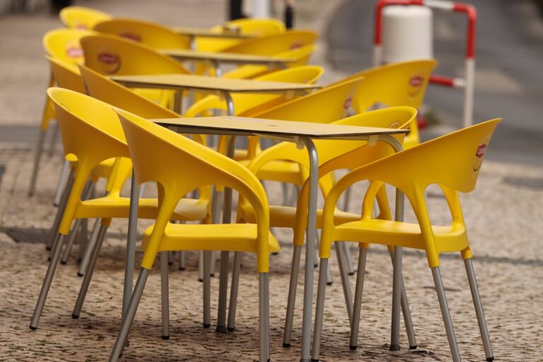 Bright Yellow Plastic Chairs and Tables on the Street